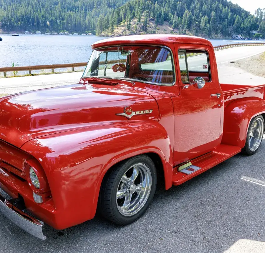 Red Ford F-100 pickup by the water
