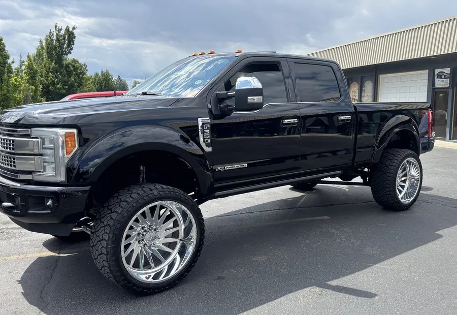 Black Ford F-350 Platinum outside the shop on North Government Way